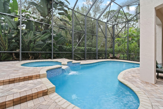 view of pool with an in ground hot tub, a lanai, pool water feature, and a patio