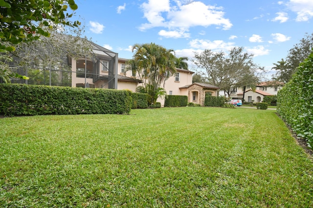 view of yard featuring a lanai