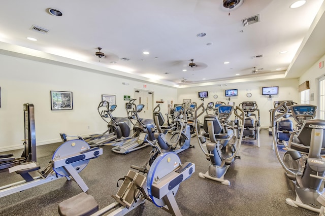 workout area featuring a raised ceiling