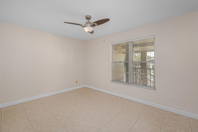 unfurnished room featuring ceiling fan and light tile patterned flooring