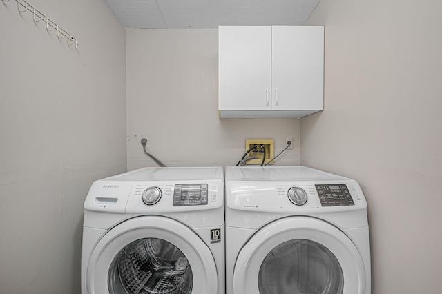 washroom with cabinets and independent washer and dryer