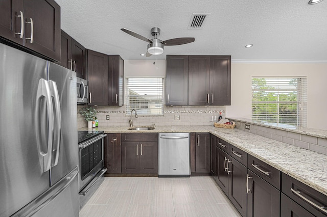 kitchen featuring crown molding, appliances with stainless steel finishes, decorative backsplash, and sink