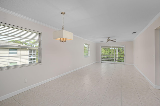 empty room with light tile patterned floors, crown molding, and ceiling fan with notable chandelier