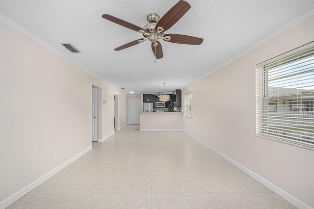 interior space with a notable chandelier, light tile patterned flooring, crown molding, and a textured ceiling