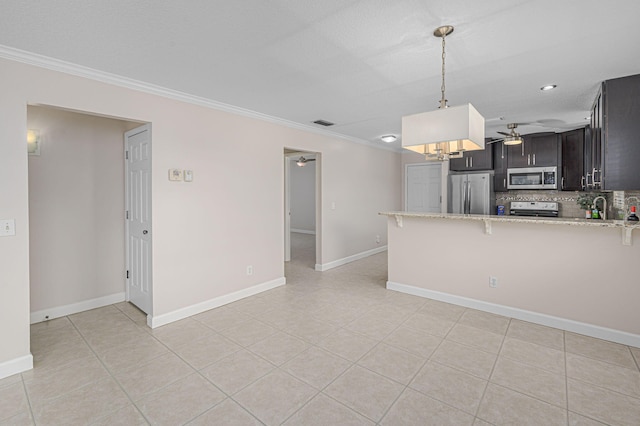 kitchen with stainless steel appliances, decorative backsplash, kitchen peninsula, ornamental molding, and ceiling fan