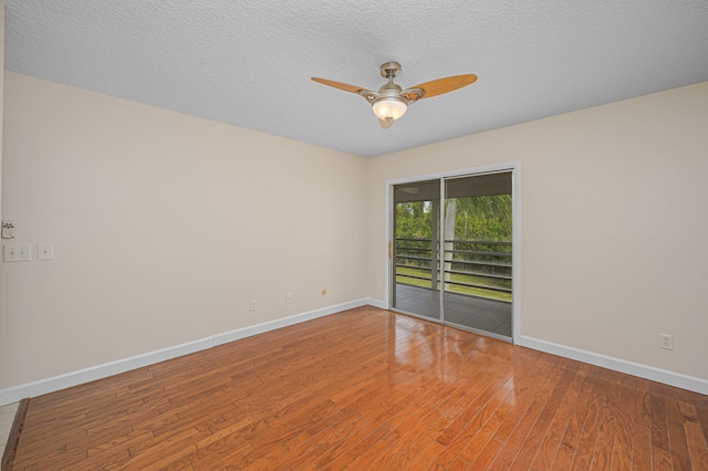 spare room featuring ceiling fan, wood-type flooring, and a textured ceiling