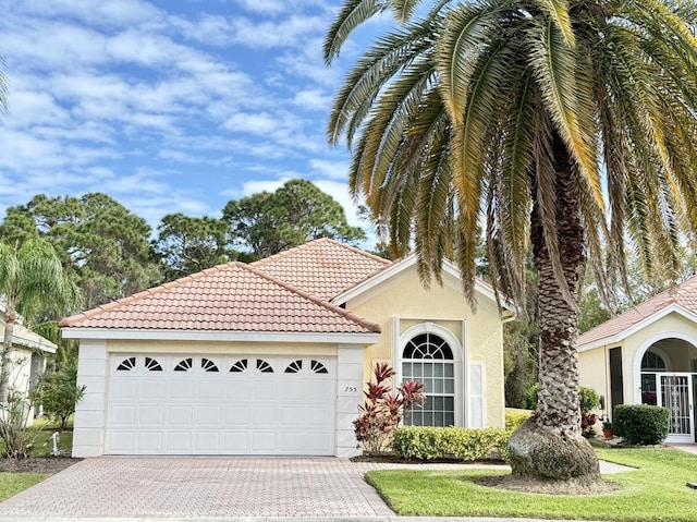 mediterranean / spanish-style home featuring a garage