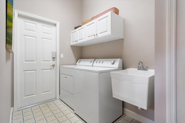 washroom with cabinets, light tile patterned floors, separate washer and dryer, and sink