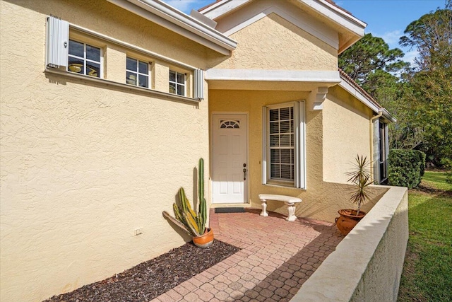 property entrance with a patio area