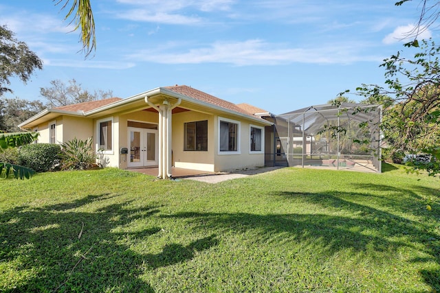 back of house with a patio, a yard, a lanai, and french doors