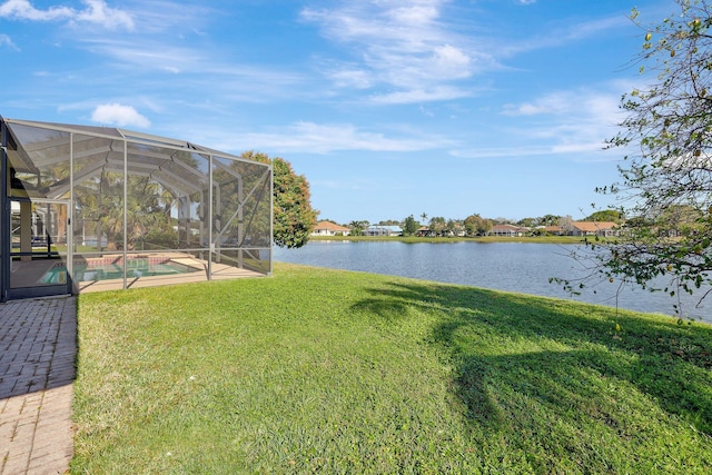 view of yard featuring a water view and a lanai