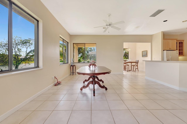 dining room with light tile patterned floors and ceiling fan