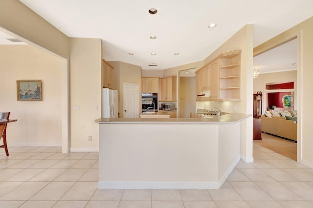 kitchen with sink, light tile patterned floors, white fridge with ice dispenser, light brown cabinetry, and kitchen peninsula