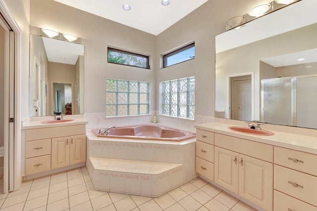 bathroom with shower with separate bathtub, tile patterned floors, and vanity