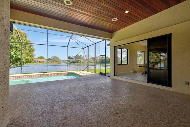 view of pool featuring a lanai, a patio, and a water view