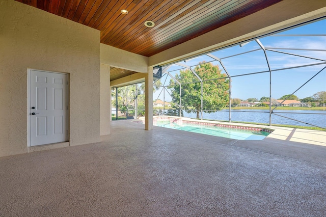 view of pool featuring a water view, a lanai, and a patio area