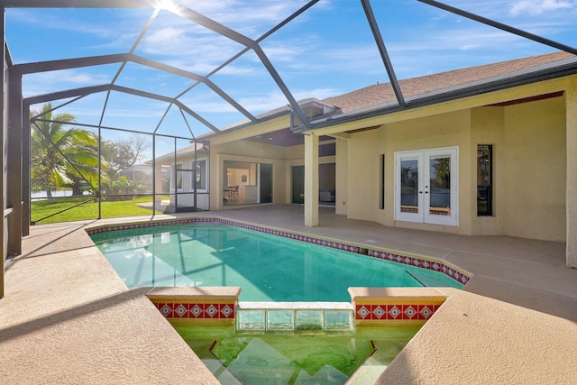 view of pool featuring a lanai, a patio area, and french doors