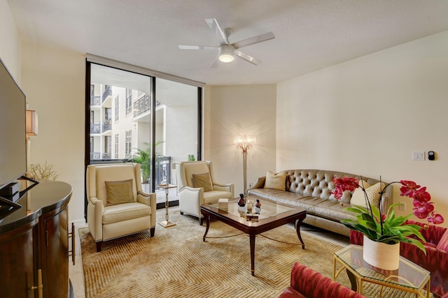 living room with ceiling fan and floor to ceiling windows