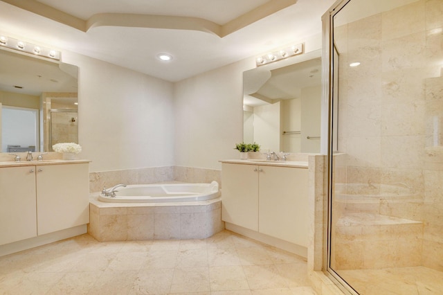 bathroom featuring shower with separate bathtub and vanity