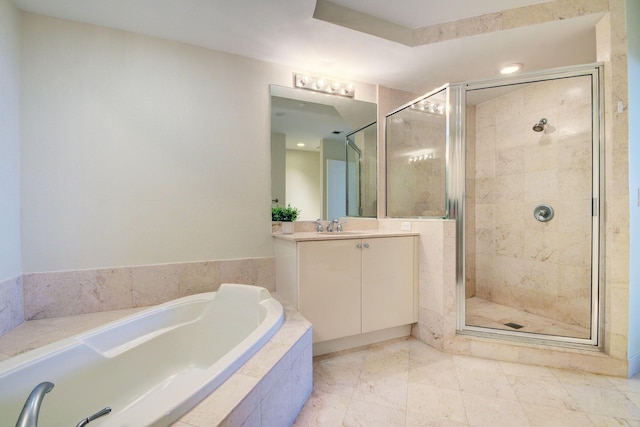 bathroom with separate shower and tub and vanity