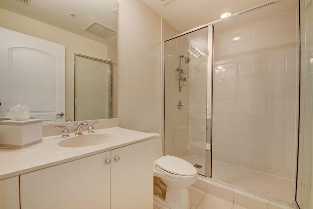 bathroom featuring toilet, walk in shower, vanity, and tile patterned flooring