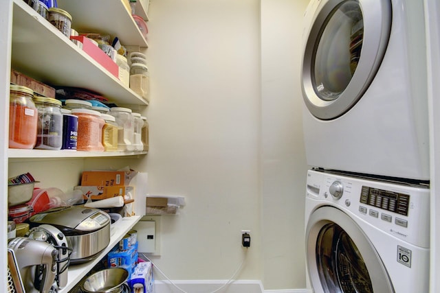 laundry area featuring stacked washer / drying machine