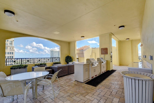 view of patio / terrace with an outdoor kitchen, sink, an outdoor hangout area, and a grill