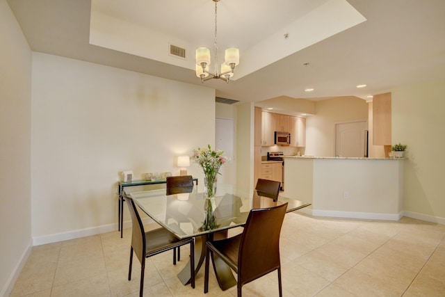 tiled dining area with an inviting chandelier