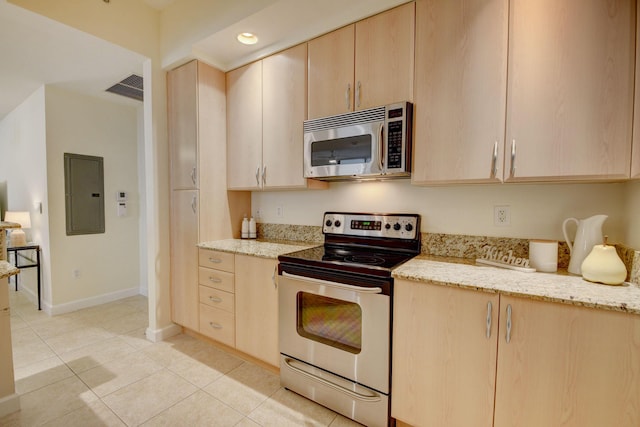 kitchen featuring electric panel, light tile patterned flooring, light brown cabinets, stainless steel appliances, and light stone counters