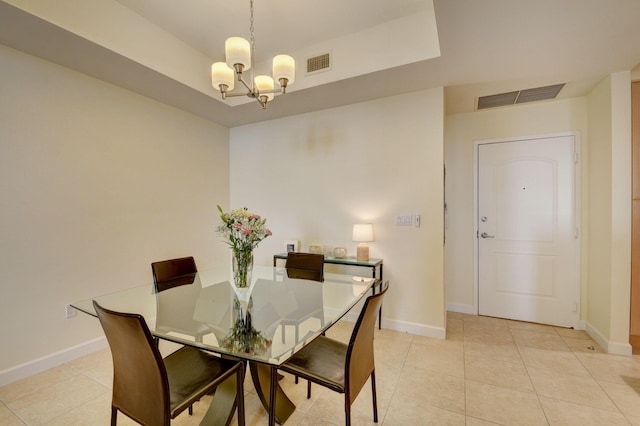 tiled dining room featuring a chandelier