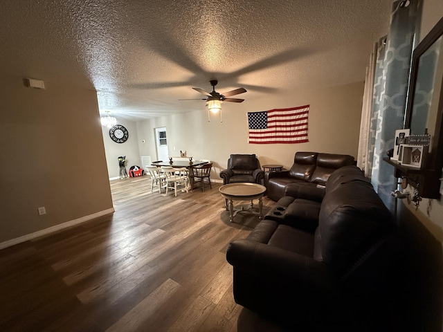 living room with a textured ceiling, ceiling fan, and hardwood / wood-style floors