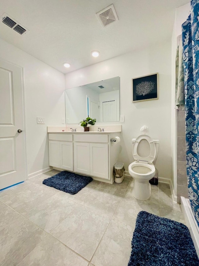 bathroom featuring curtained shower, toilet, vanity, and tile patterned flooring