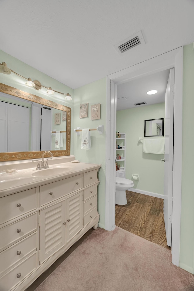 bathroom featuring toilet and vanity