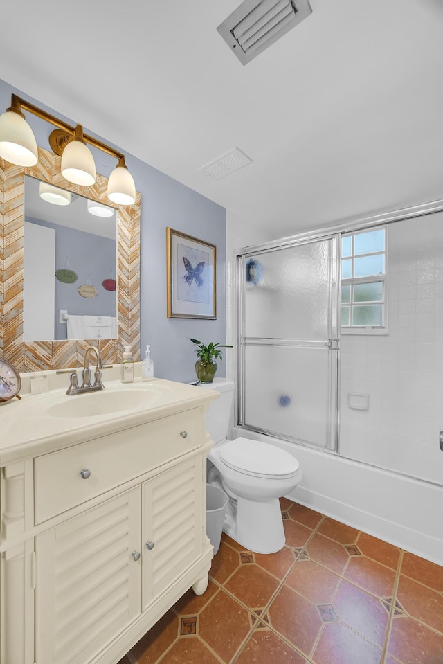 full bathroom with toilet, tile patterned flooring, vanity, and shower / bath combination with glass door