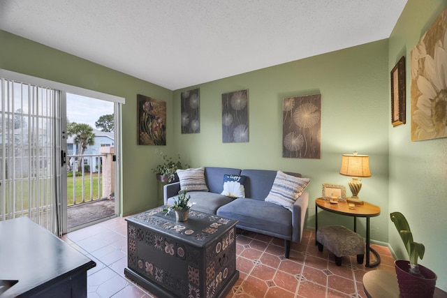 living room with tile patterned flooring and a textured ceiling