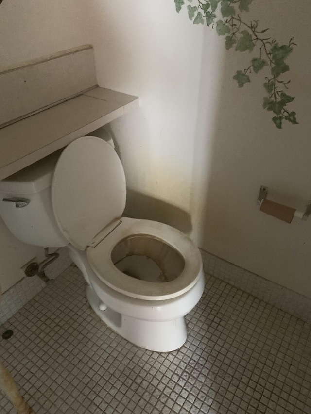 bathroom with toilet and tile patterned floors