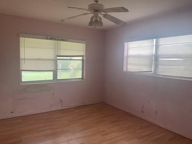 unfurnished room with a textured ceiling, ceiling fan, and light hardwood / wood-style floors