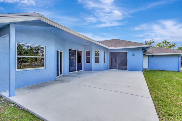 12855 87th St N, West Palm Beach, FL 33412 - rear view of property with a patio area, stucco siding, a lawn, and roof with shingles