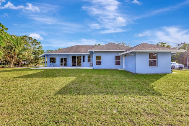 12855 87th St N, West Palm Beach, FL 33412 - rear view of property with stucco siding, a lawn, a patio, and roof with shingles