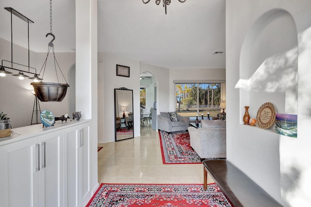 12855 87th St N, West Palm Beach, FL 33412 - corridor featuring arched walkways and light tile patterned floors