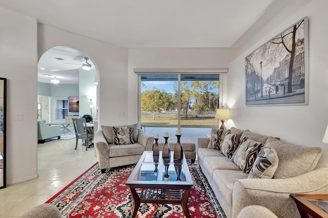 living room with ceiling fan and light tile patterned flooring