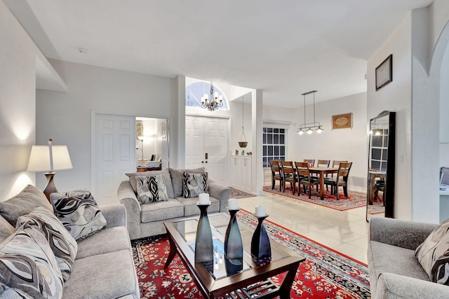 living room featuring a notable chandelier and tile patterned floors