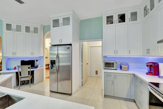 12855 87th St N, West Palm Beach, FL 33412 - kitchen featuring appliances with stainless steel finishes, tasteful backsplash, light countertops, and light tile patterned floors