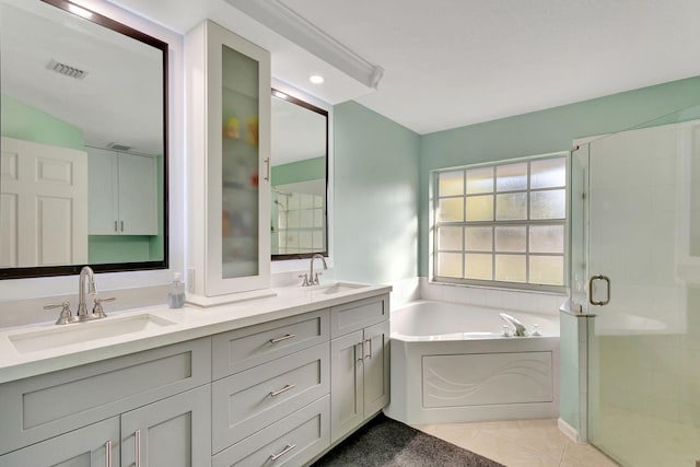 bathroom featuring vanity, tile patterned flooring, and separate shower and tub