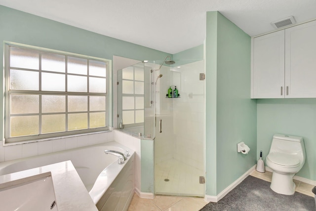 bathroom with plus walk in shower, tile patterned floors, and toilet