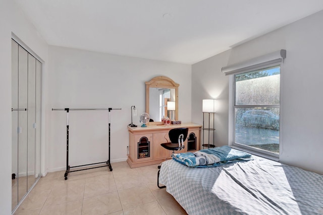 bedroom featuring light tile patterned floors and a closet