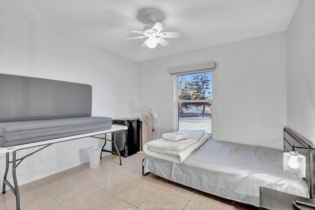 tiled bedroom featuring ceiling fan