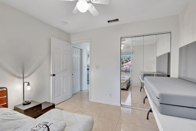 tiled bedroom with a closet and ceiling fan