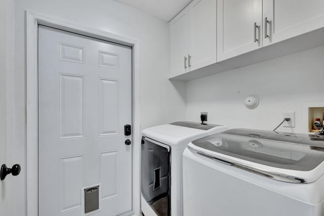 laundry area with cabinets and washing machine and dryer