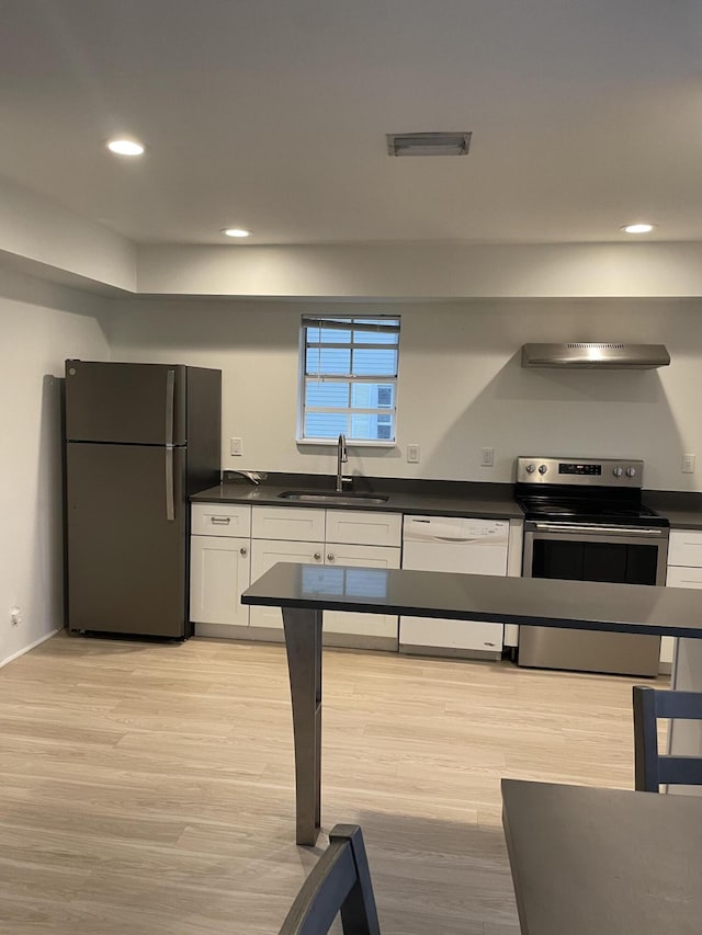 kitchen featuring stainless steel range with electric stovetop, white cabinetry, white dishwasher, refrigerator, and sink